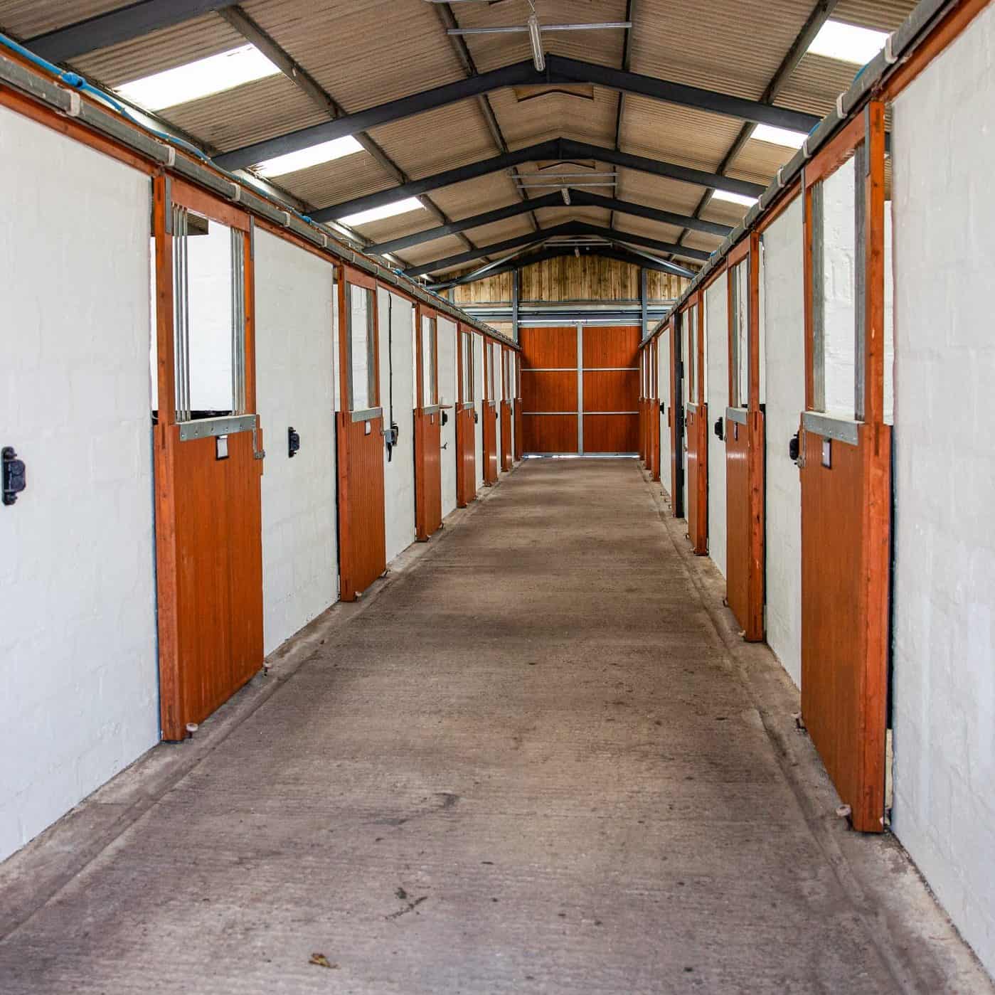 Row of indoor stables at Downclose Stables
