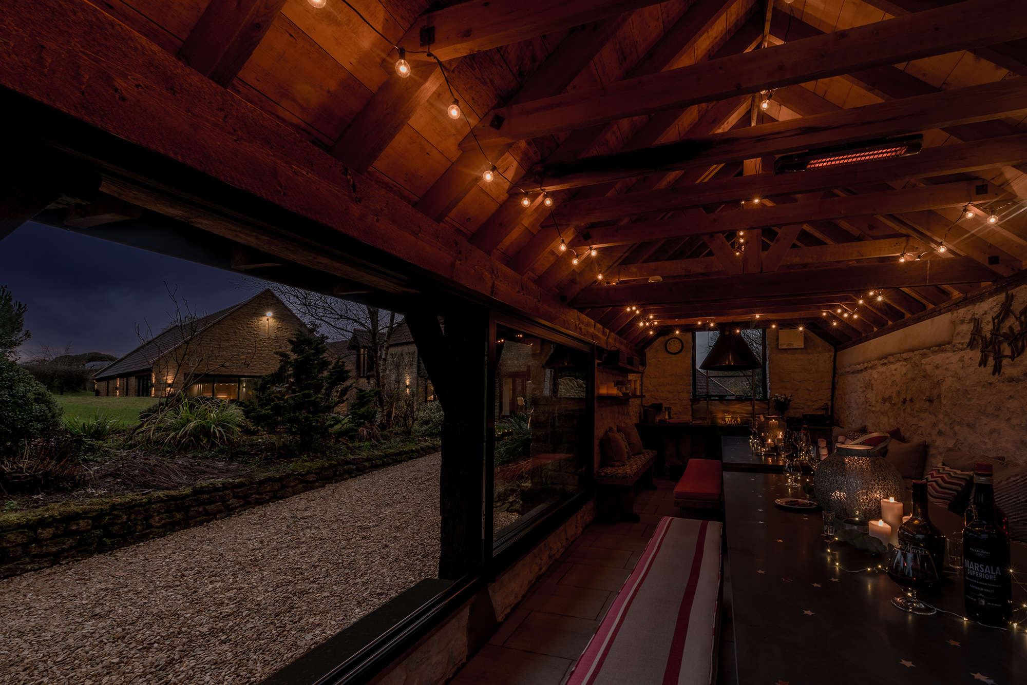 Barbecue lodge lit up with festoon lights at Kingshay Barton