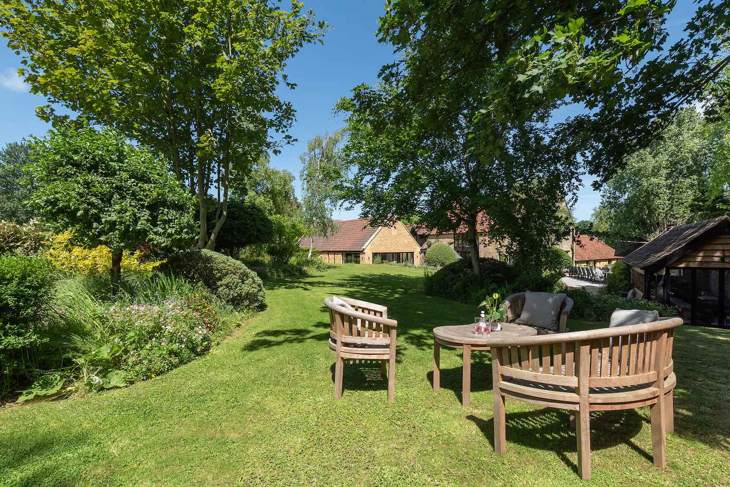 Outdoor seating in garden at Kingshay Barton