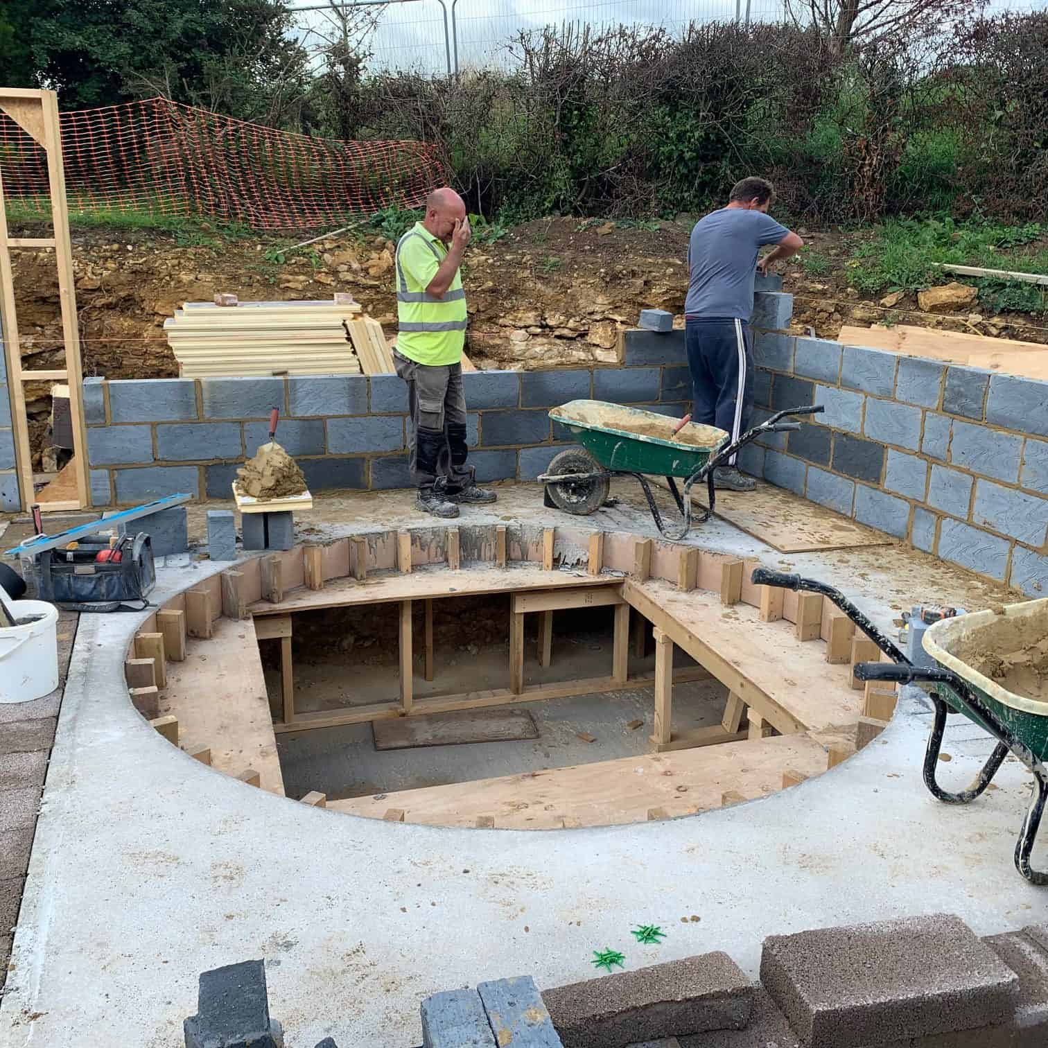 Builders working on hot tub cavity