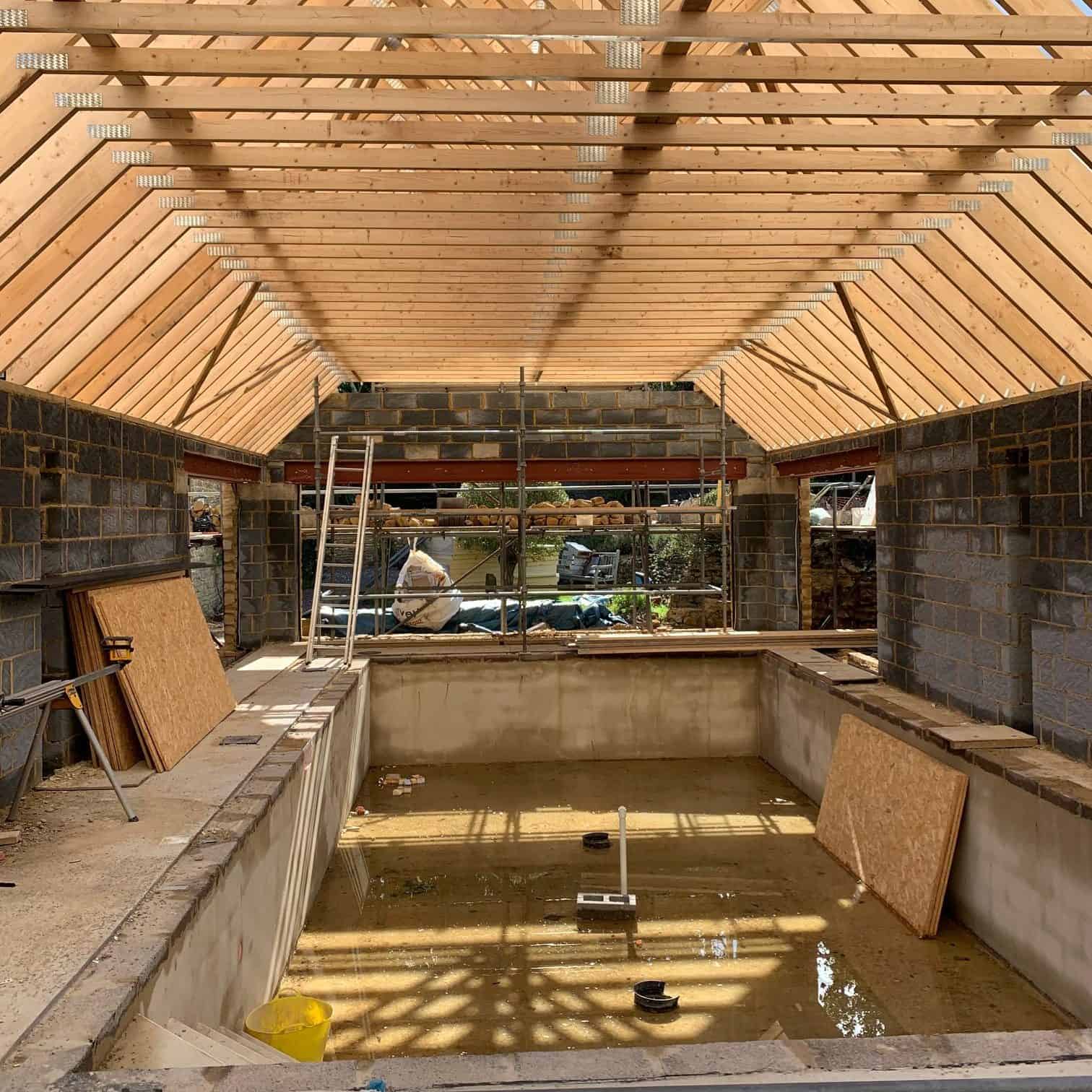 Construction of indoor swimming pool with rafters installed