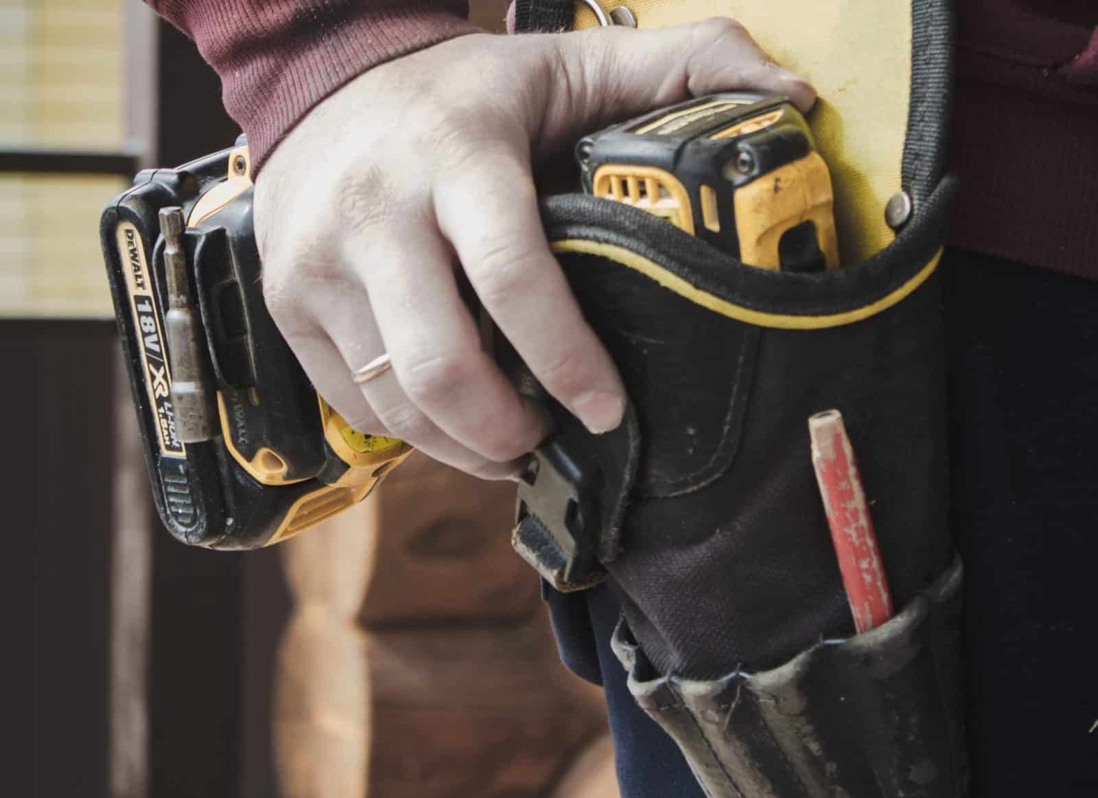 Builders hand holding drill